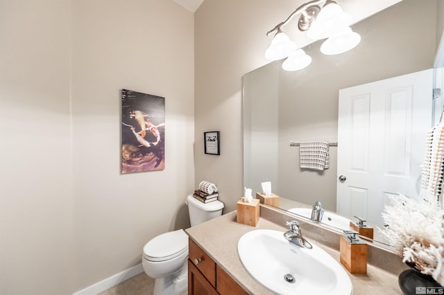 bathroom featuring vanity, tile patterned floors, and toilet