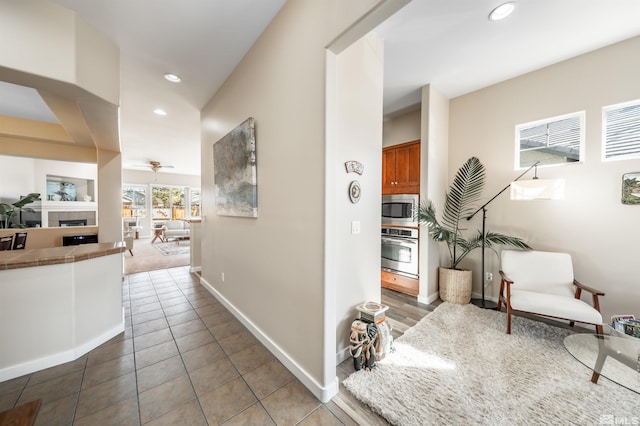 hall with tile patterned floors