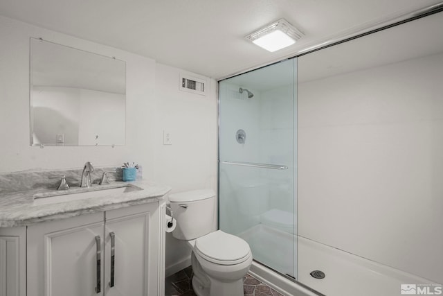 bathroom with vanity, toilet, and walk in shower