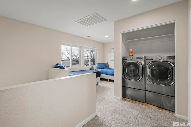 laundry area featuring independent washer and dryer and light colored carpet