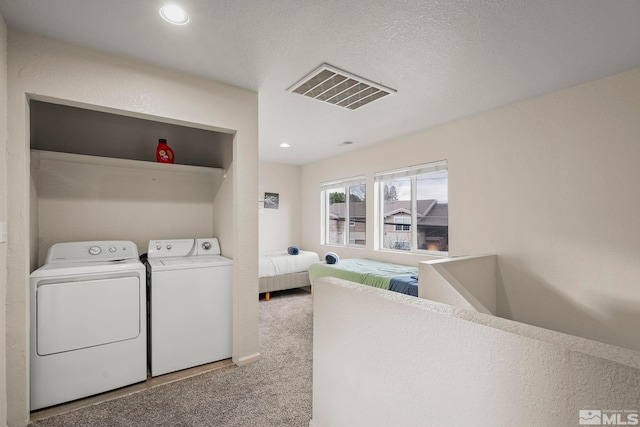 laundry room with independent washer and dryer and carpet