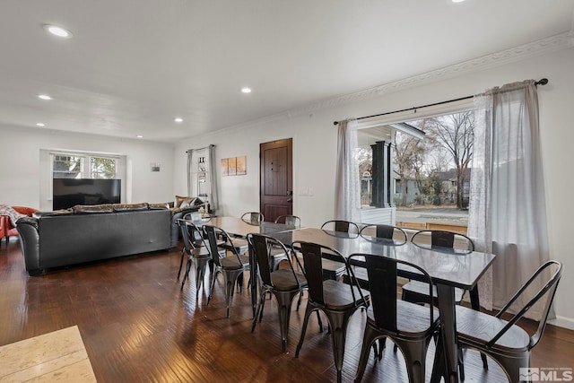 dining area with crown molding and dark hardwood / wood-style floors