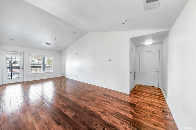 empty room featuring dark hardwood / wood-style floors and vaulted ceiling