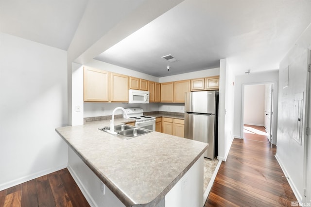 kitchen with sink, dark hardwood / wood-style flooring, kitchen peninsula, light brown cabinets, and white appliances