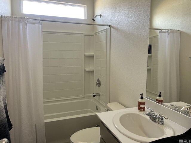 full bathroom with shower / tub combo, vanity, toilet, and a healthy amount of sunlight