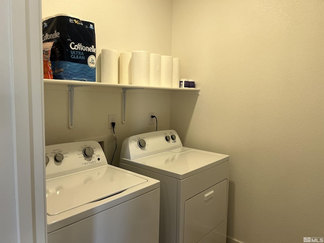clothes washing area with separate washer and dryer