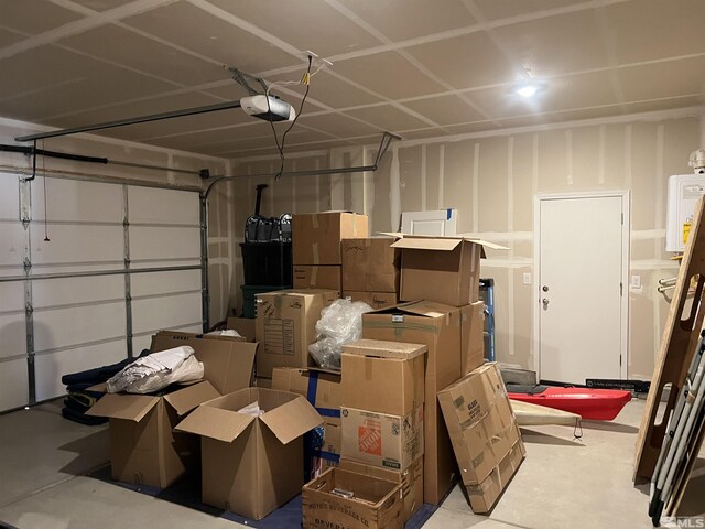 garage with a garage door opener and water heater