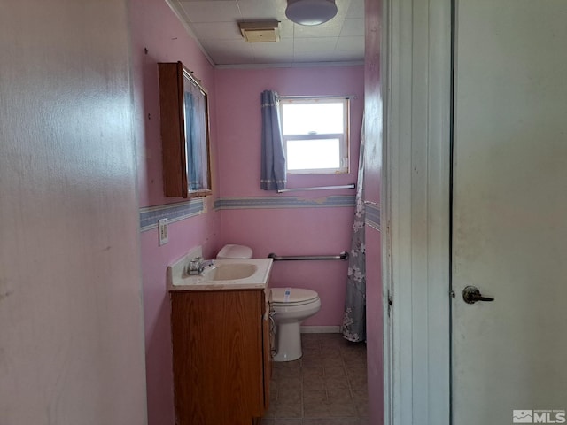 bathroom with vanity, toilet, and tile patterned flooring