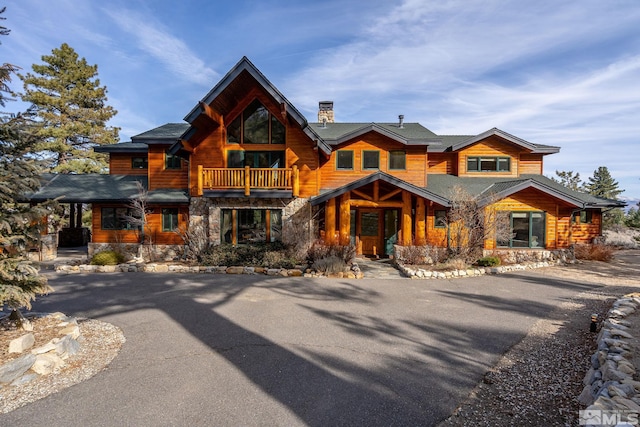 log-style house featuring a balcony