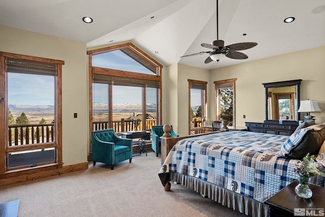 bedroom featuring multiple windows, a mountain view, access to outside, and light carpet