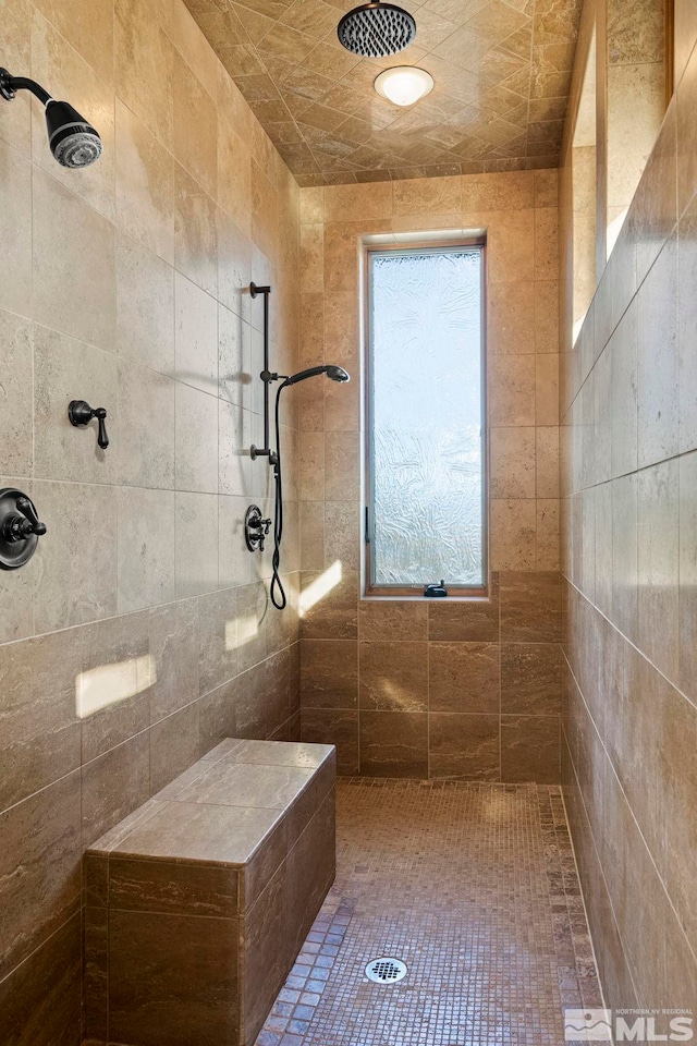 bathroom with tiled shower