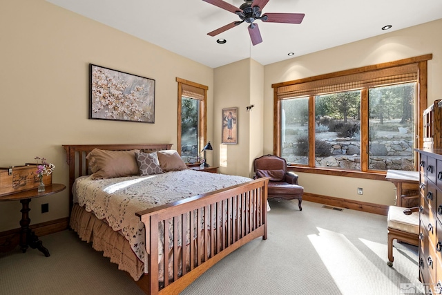 bedroom featuring light carpet and ceiling fan