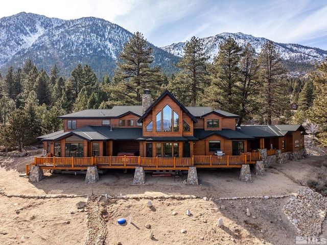 back of house featuring a deck with mountain view