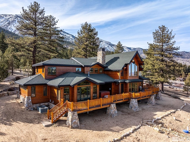 rear view of house with central AC and a deck with mountain view