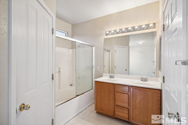 bathroom featuring vanity and bath / shower combo with glass door