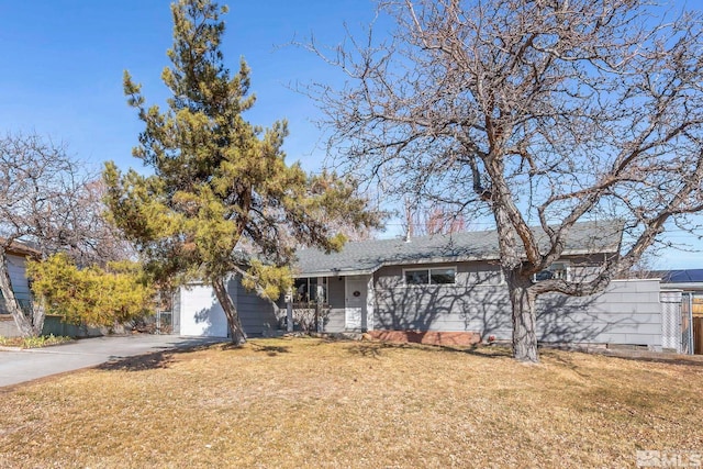 ranch-style home with a garage and a front yard