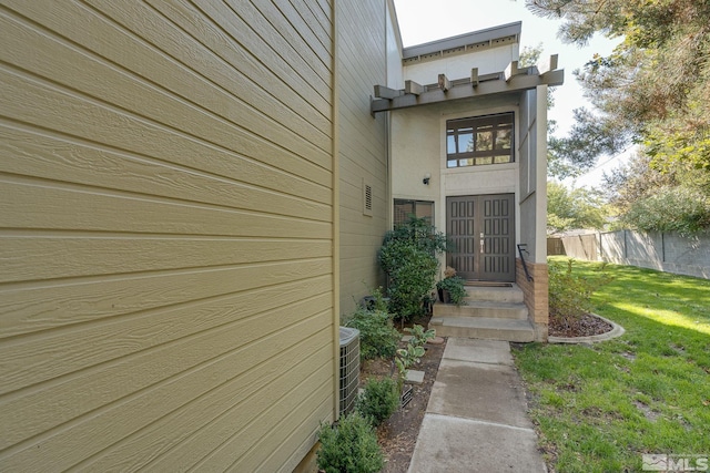 doorway to property featuring a yard