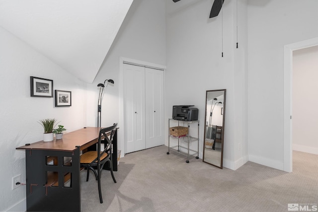 carpeted home office featuring high vaulted ceiling and ceiling fan