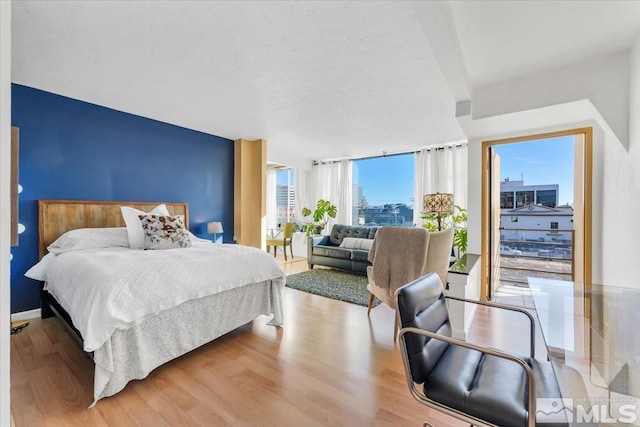 bedroom featuring hardwood / wood-style floors and a textured ceiling