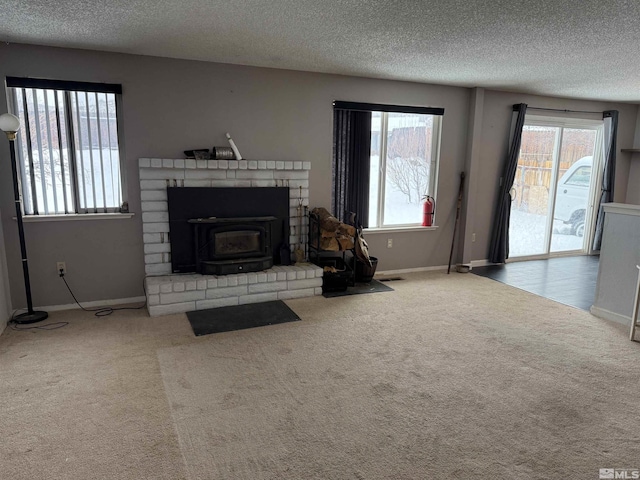 living area with plenty of natural light, a textured ceiling, and carpet