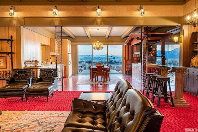 living room featuring an inviting chandelier, a mountain view, and beam ceiling