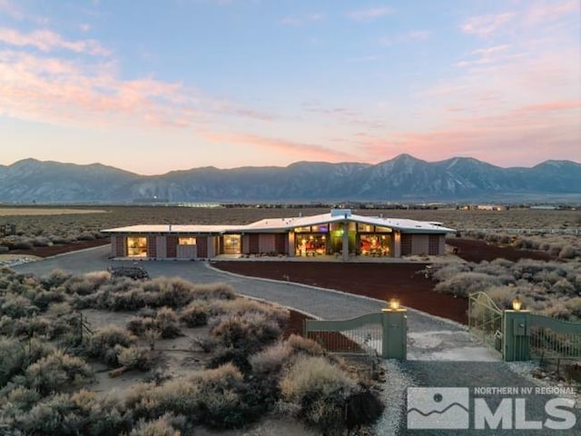 back house at dusk with a mountain view