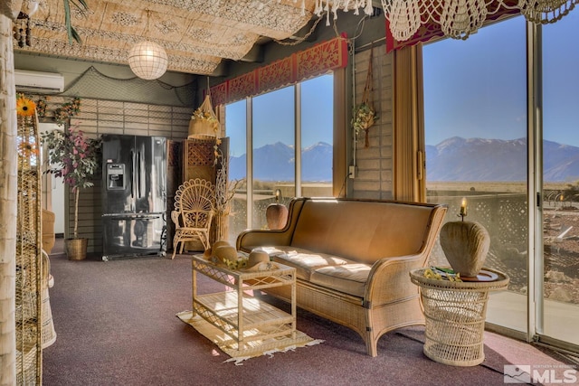sunroom / solarium with a mountain view and an AC wall unit
