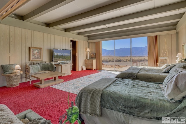 bedroom featuring wood walls, beam ceiling, carpet floors, and access to outside