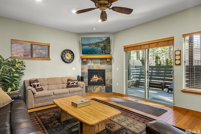 living room featuring hardwood / wood-style floors and ceiling fan