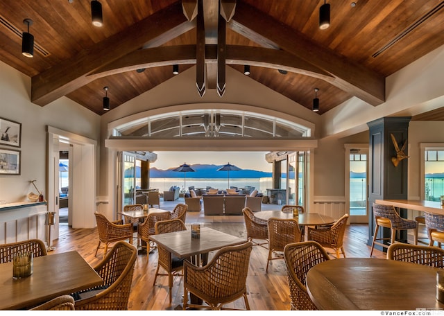 living room with a healthy amount of sunlight, wood ceiling, and light hardwood / wood-style flooring