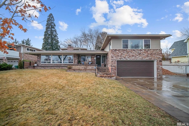 split level home with a garage and a front yard