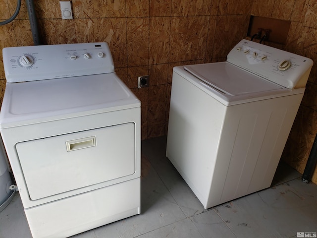 laundry area featuring independent washer and dryer and tile walls