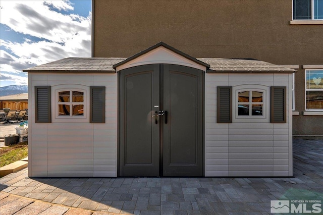 view of outbuilding featuring a mountain view