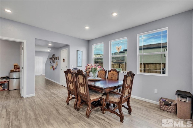 dining area featuring light wood-type flooring