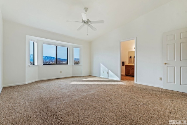 carpeted spare room featuring lofted ceiling and ceiling fan