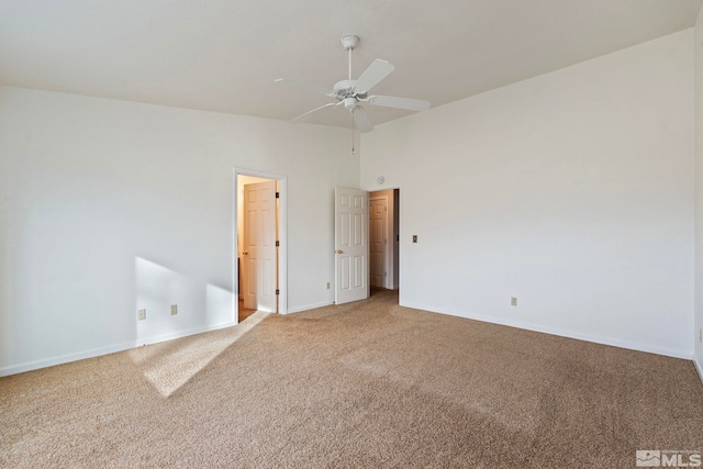 carpeted spare room with ceiling fan and high vaulted ceiling