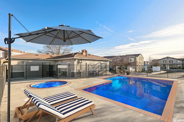view of pool with an in ground hot tub and a patio