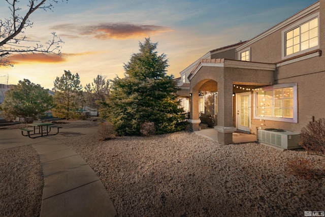 exterior space with central AC and a patio