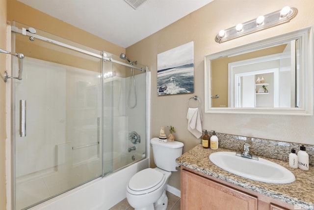 full bathroom featuring enclosed tub / shower combo, vanity, toilet, and tile patterned flooring