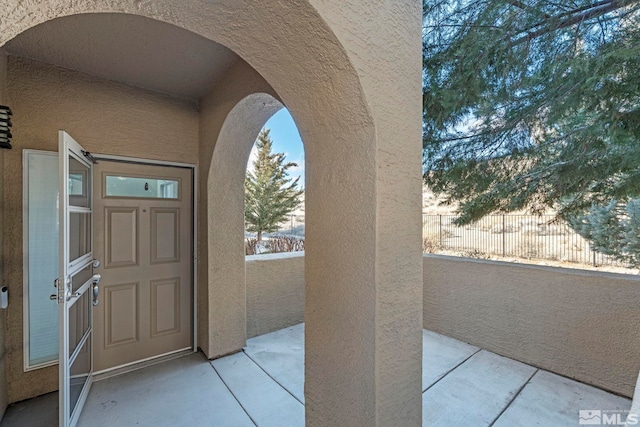 view of exterior entry featuring a balcony