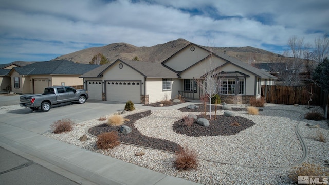 ranch-style home with a mountain view and a garage