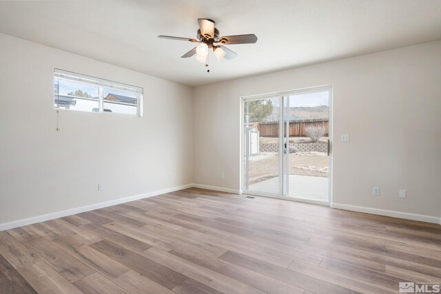 empty room featuring ceiling fan and light wood-type flooring