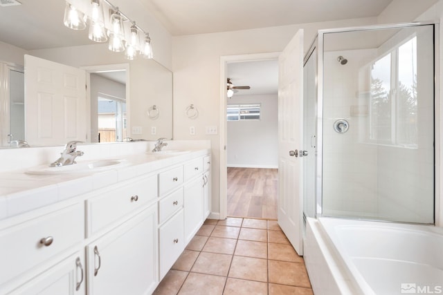 bathroom featuring ceiling fan, tile patterned floors, plus walk in shower, and vanity