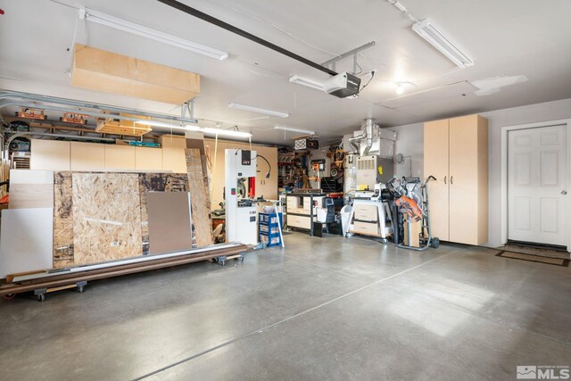 garage with a garage door opener and a workshop area