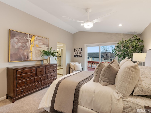 carpeted bedroom featuring ceiling fan, ensuite bathroom, vaulted ceiling, and access to outside