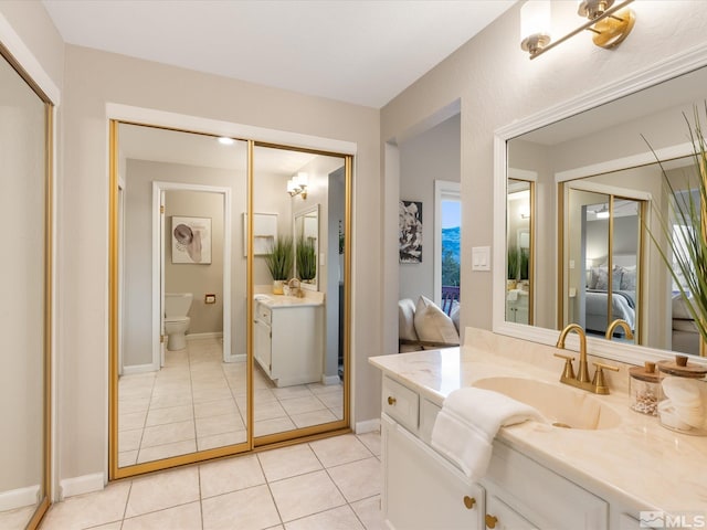 bathroom with vanity, tile patterned floors, and toilet