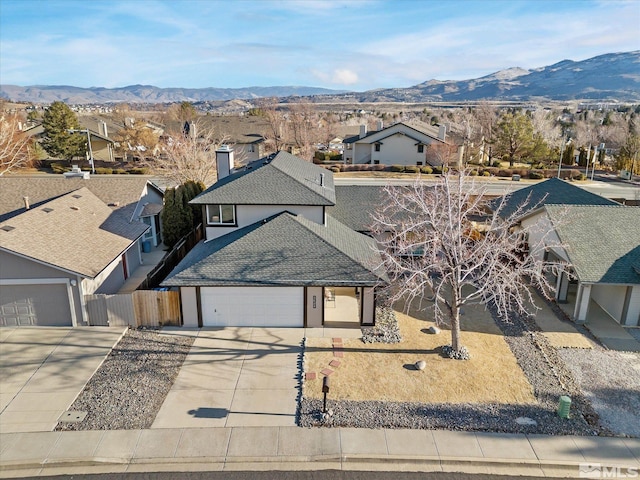 view of front of home with a mountain view and a garage