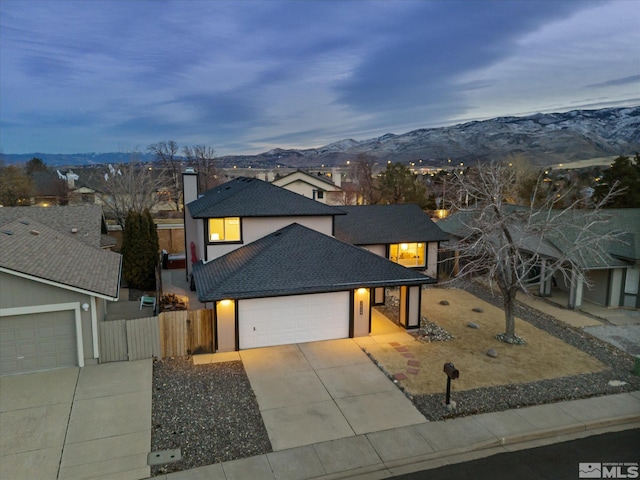 view of front of property with a garage and a mountain view