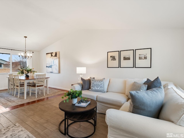 living room featuring an inviting chandelier, wood-type flooring, and vaulted ceiling