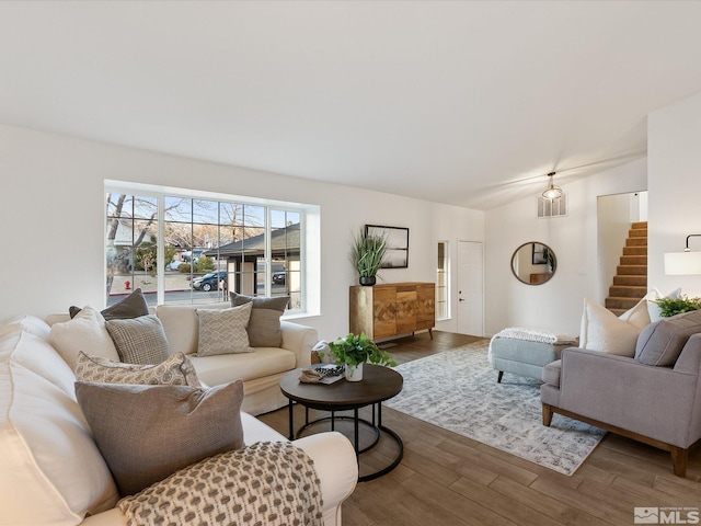 living room featuring lofted ceiling and dark hardwood / wood-style floors